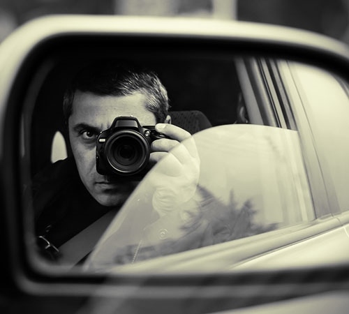 man conducts the hidden photographing with the car